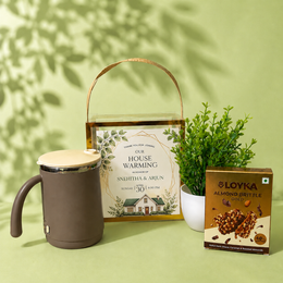 Personalized Housewarming Return Gift Hamper with Stainless Steel Mug, Artificial Plant & Almond Brittle | Premium PVC Gift Box